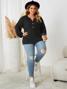 Detail of plus size black top with v-neck button design and sheer mesh polka dot sleeves