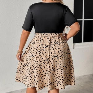 Rear view detail of a plus size V-neck dress featuring black top and leopard print skirt