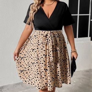 Detailed view of the V-neck bodice and tie-waist on this polka dot plus size dress