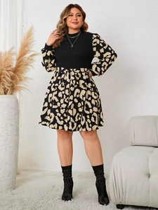 Detail of plus size dress featuring ribbed black knit bodice and leopard print skirt