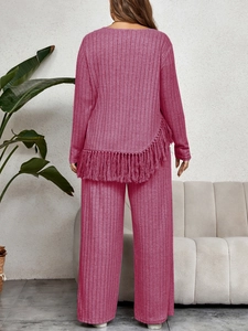 Detailed back view of magenta ribbed knit set featuring asymmetrical fringe hem and wide-leg pants