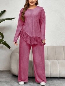 Detail of plum red ribbed knit two-piece set featuring asymmetrical fringe hem and wide-leg pants