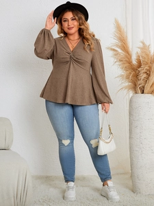 Detail of coffee brown V-neck top with knot front and stylish puff long sleeves
