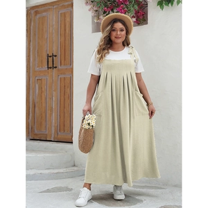 Detail of beige plus size pinafore dress featuring textured fabric and oversized side pockets