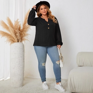 Women's plus size black knit top with lace patchwork sleeves and buttoned V-neckline
