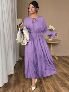 Detailed view of purple polka dot maxi dress with tie neckline and flared cuffs