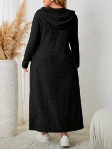 Back view of a plus-size long-sleeved hooded black maxi dress on a model in a studio
