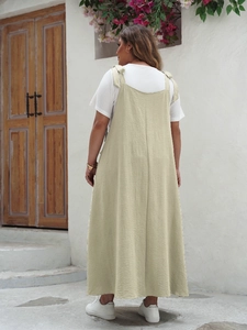 Detail of white T-shirt and olive green pleated maxi dress back with seam line