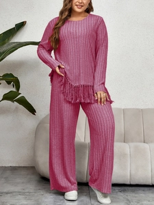 Detail of berry red ribbed lounge set featuring fringe hem top and wide-leg trousers