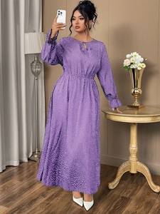 Detail of purple floral polka dot dress featuring elastic ruffled cuffs and a high waist