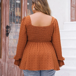 Detail of the caramel Swiss dot smocked back design and elastic ruffled cuffs on the top