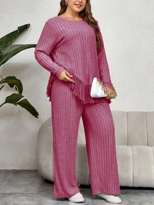 Detail of rose pink knit set featuring irregular tassel hem and ribbed texture fabric