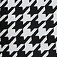 Close-up of classic houndstooth fabric texture for vintage V-neck long sleeve dress