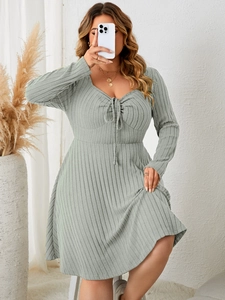 Detailed view of the sage green ribbed fabric texture and ruched tie-up front design