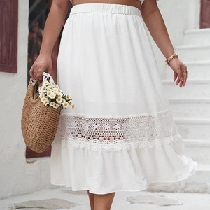 Detailed view of white midi skirt with elastic waist and hollow out lace floral embroidery
