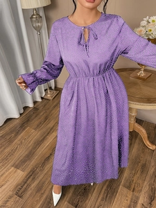Detail of purple polka dot maxi dress featuring a tie-neckline and elastic waist