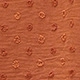 Detailed view of terracotta Swiss dot fabric with textured chiffon finish on the top