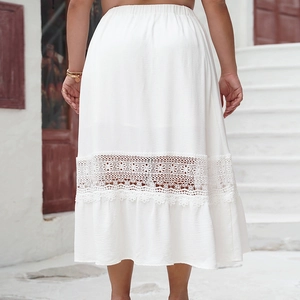 Detail of white midi skirt featuring elastic waist and intricate floral lace hemline