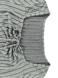 Detail of grey striped knit fabric featuring square neck and gathered drawstring design