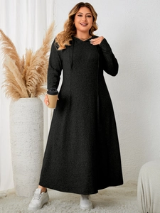 Detail view of the black plus-size hooded A-line dress showing the soft knitted fabric texture