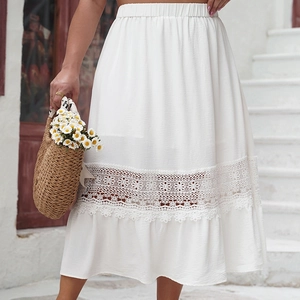 Detail of white A-line midi skirt featuring floral lace hollow hem and pleated waist