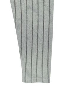 Detail shot of the gray knitted striped fabric texture and stitched cuff of the dress