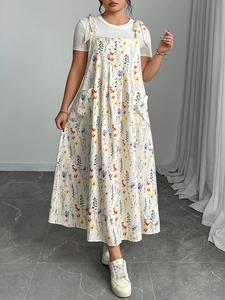 Detailed view of floral strap dress with white t-shirt and large functional pockets