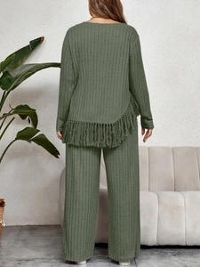 Detail of olive green ribbed knit set featuring asymmetrical fringed hem and wide legs