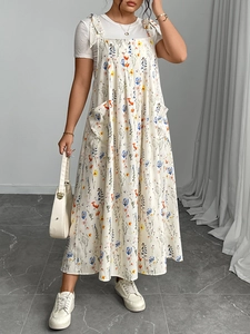 Detail of adjustable bow straps and floral print on a summer maxi dress with pockets