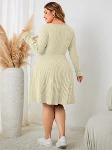 Detail view of the ribbed fabric and tailored back of the beige plus-size long sleeve dress