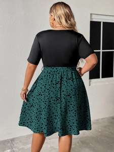 Back view of plus size patchwork dress featuring black bodice and animal print skirt
