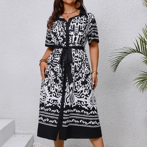 Detail of short sleeves and collar on black and white baroque print dress with waist tie