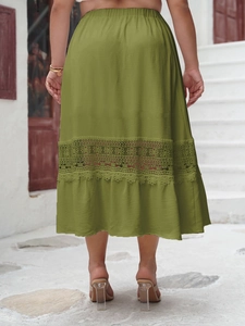 Detail of olive green midi skirt featuring elastic waist and intricate lace cutout hem