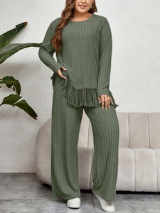 Detail of grey-green ribbed knit set showing unique tassel hem and textured fabric finish