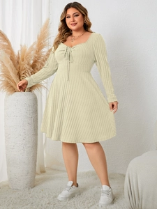 Detail of long sleeve square neck dress showing vertical stripe texture and drawstring