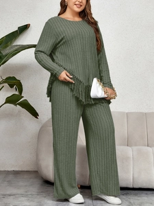 Close-up of olive green ribbed knit fabric featuring long fringes and vertical texture