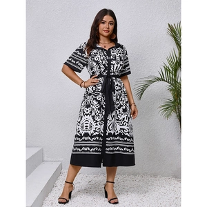 Elegant V-neck boho midi dress with black and white print and waist tie closure