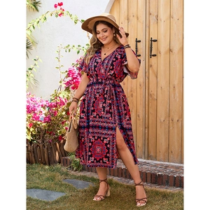 Detail of bohemian V-neck dress with ethnic print, flutter sleeves and high side slit