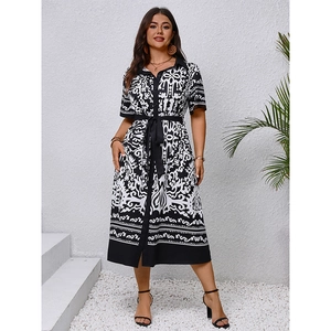 Elegant black and white printed shirt dress with waist tie and geometric pattern