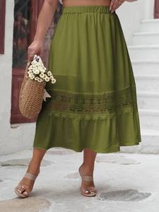 Detail of olive green midi skirt featuring elastic waist and intricate lace hollow embroidery