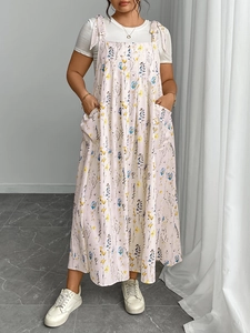 Close-up of women's floral overall dress with white T-shirt and large front pockets