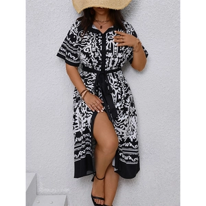 Detail of bohemian black and white geometric print shirt dress with tie waist and side slit