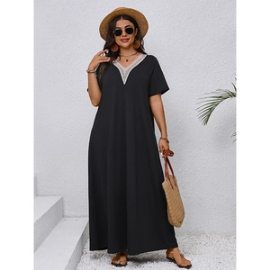 Close-up of elegant V-neckline with delicate white lace crochet on a black maxi dress
