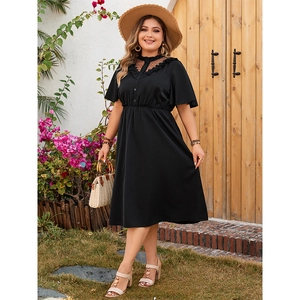 Elegant plus size black V-neck dress with mesh polka dot details and ruffled sleeves
