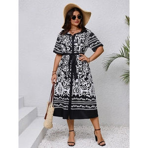 Detail of summer shirt dress with black and white geometric print and waist tie
