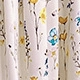 Detail shot of summer dress fabric featuring blue and yellow floral print and butterflies