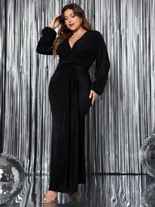 Detailed view of the deep V-neck and twisted waist on this black shimmering evening gown