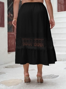 Detail of elegant black long skirt with delicate lace cutout hem and elastic waistband
