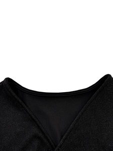 Detailed view of black V-neckline featuring shimmering metallic knit fabric texture