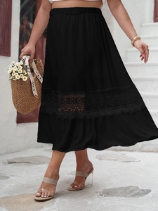 Close-up of black high-waisted skirt featuring lace hollow stitching and ruffle hem detail